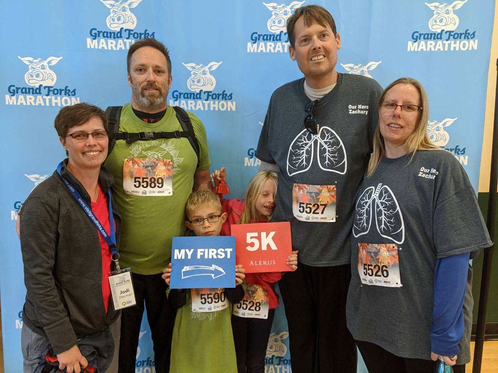 Kurt and Jodi Sherman, and Shannon and Tracy Mohn smile for picture at the Grand Forks Marathon 5K.